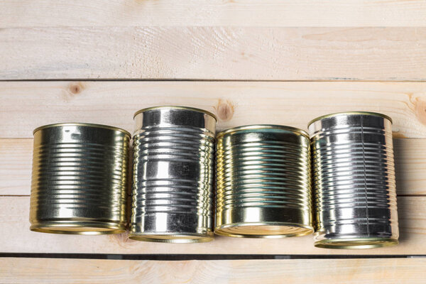 Tin cans for food on wooden background