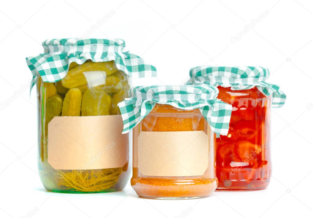 Canned vegetables in glass jars isolated on white background