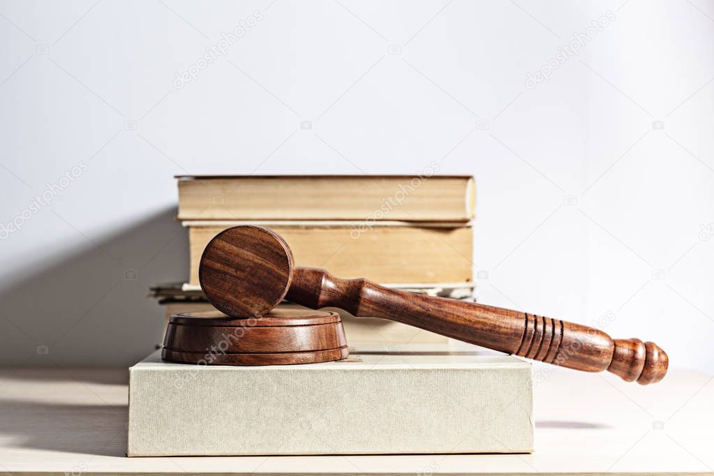 Gavel and handcuffs on light background