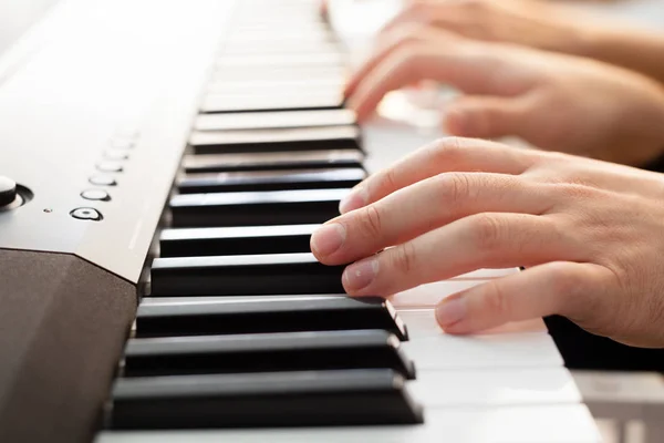 Closeup of hands playing piano, Music and hobby concept