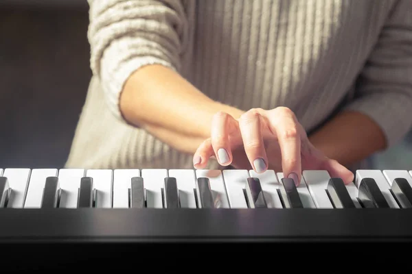 Closeup of hand playing piano, Music and hobby concept