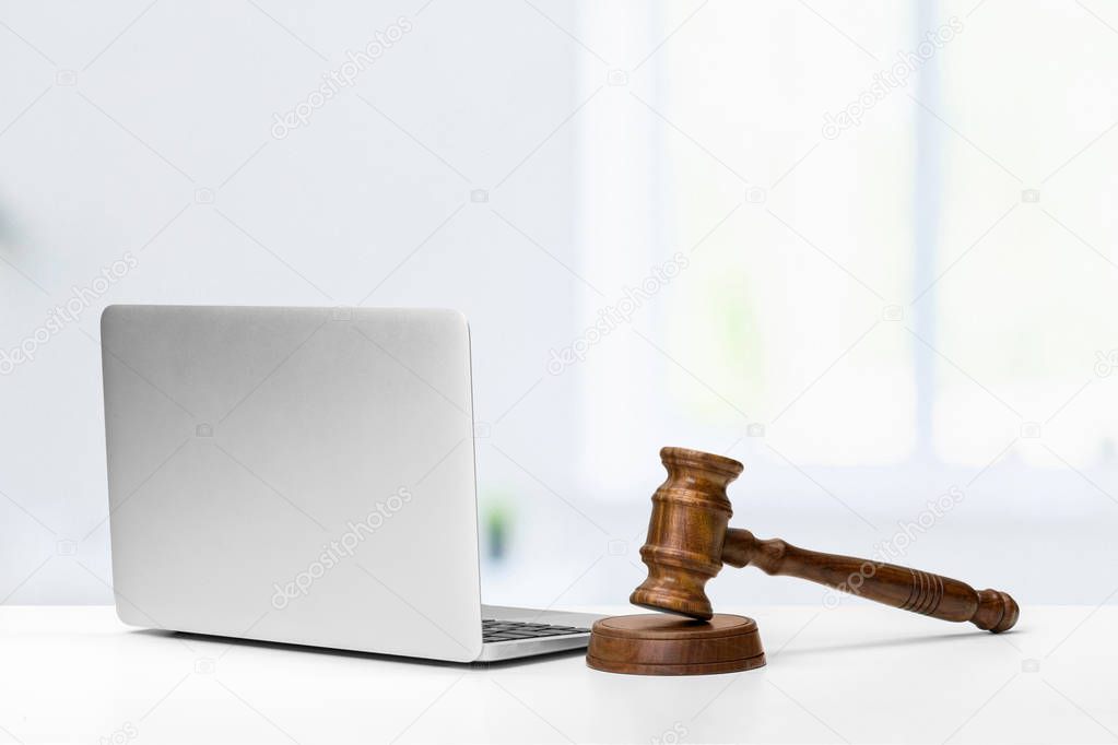 Laptop And Mallet On Table, close-up view 