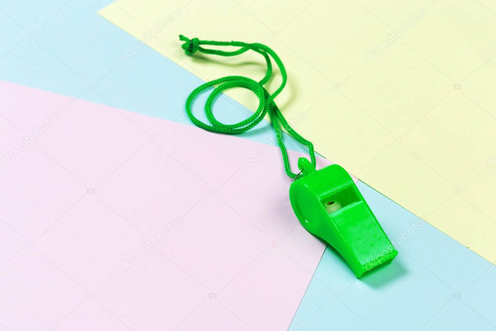 Referee Whistle on light colorful background