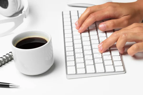 women\'s hands using keyboard and mouse