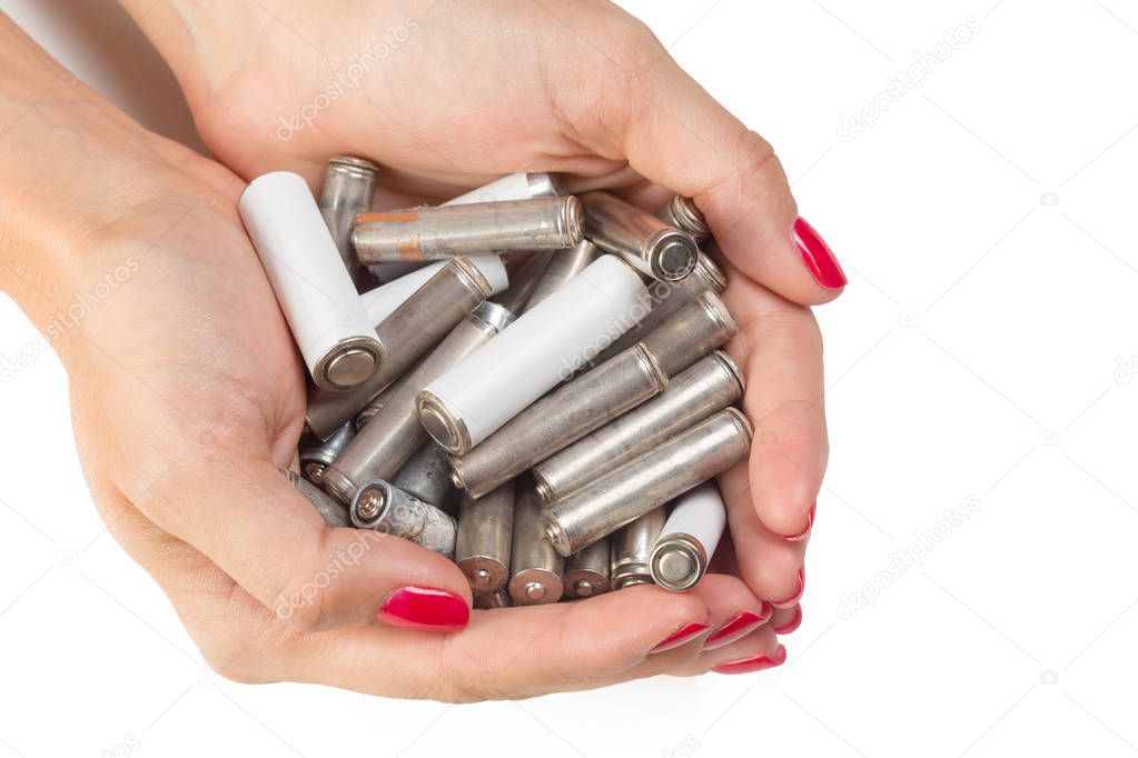 Batteries in hands isolated on white background