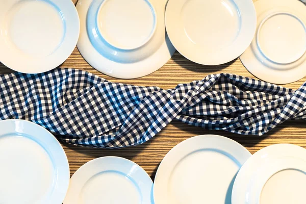 table with blue picnic cloth and plate