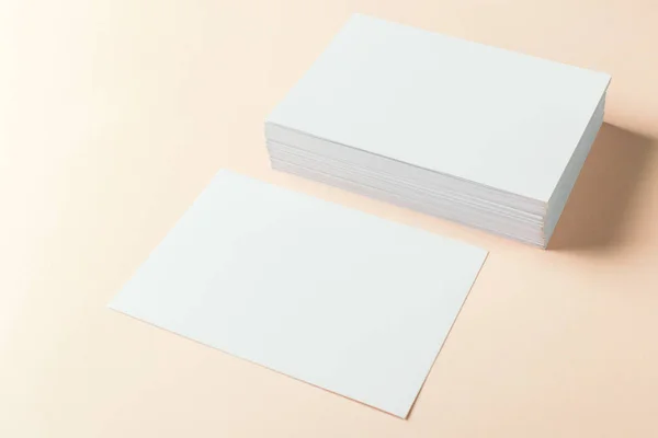 paper blank business cards on beige background, close-up