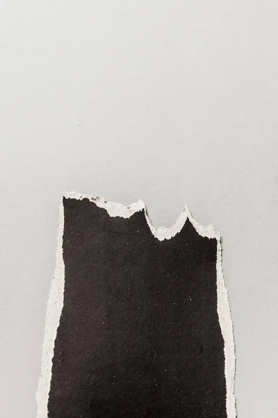 Zwarte Gescheurd Papier Een Grijze Achtergrond Close — Stockfoto