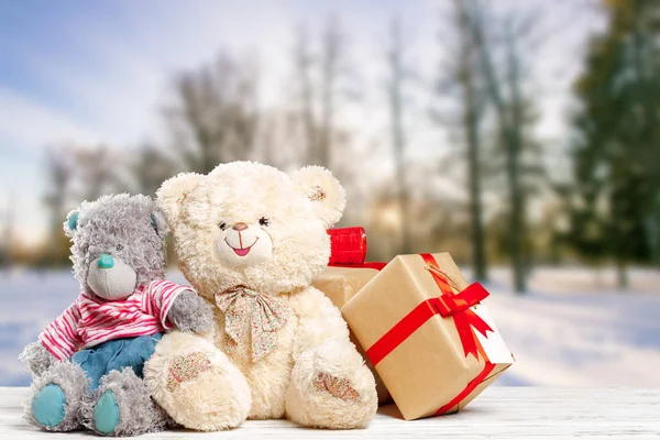 gift boxes with teddy bears on old table, close-up