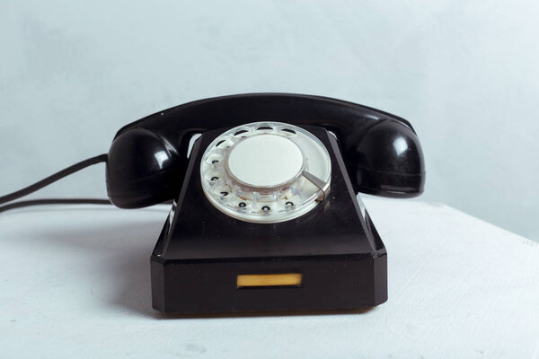 close-up view of black Retro telephone on white table
