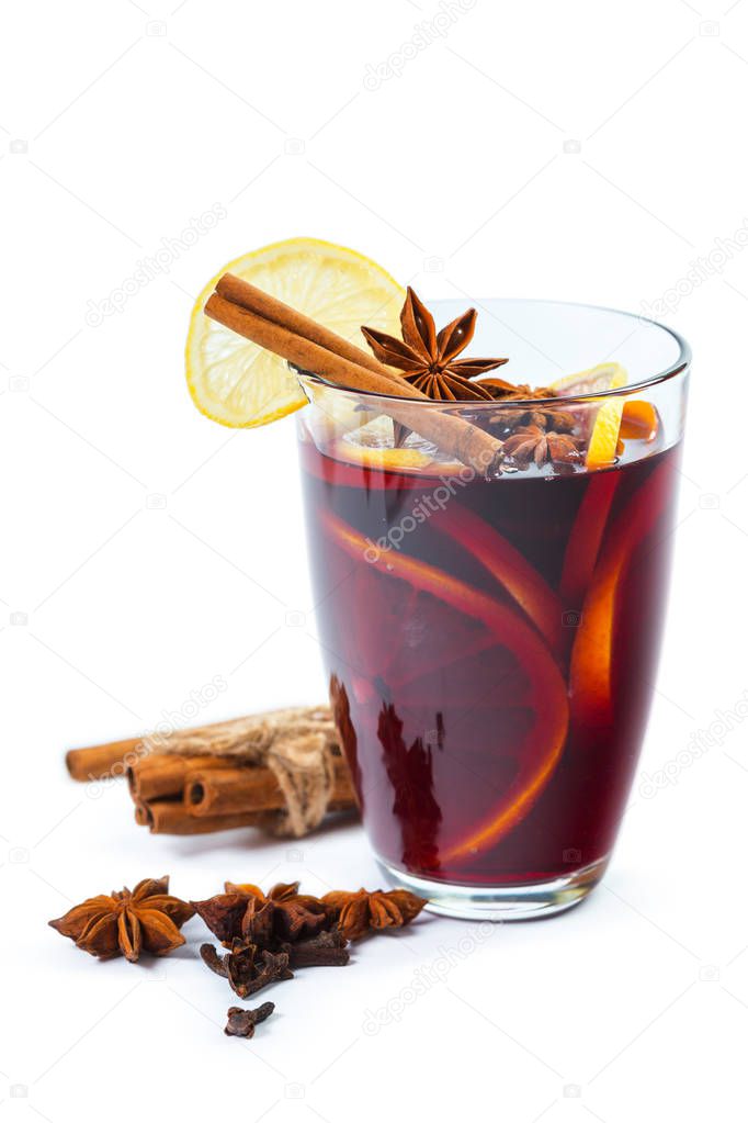 Cup of hot wine with spices isolated on white background, close-up 