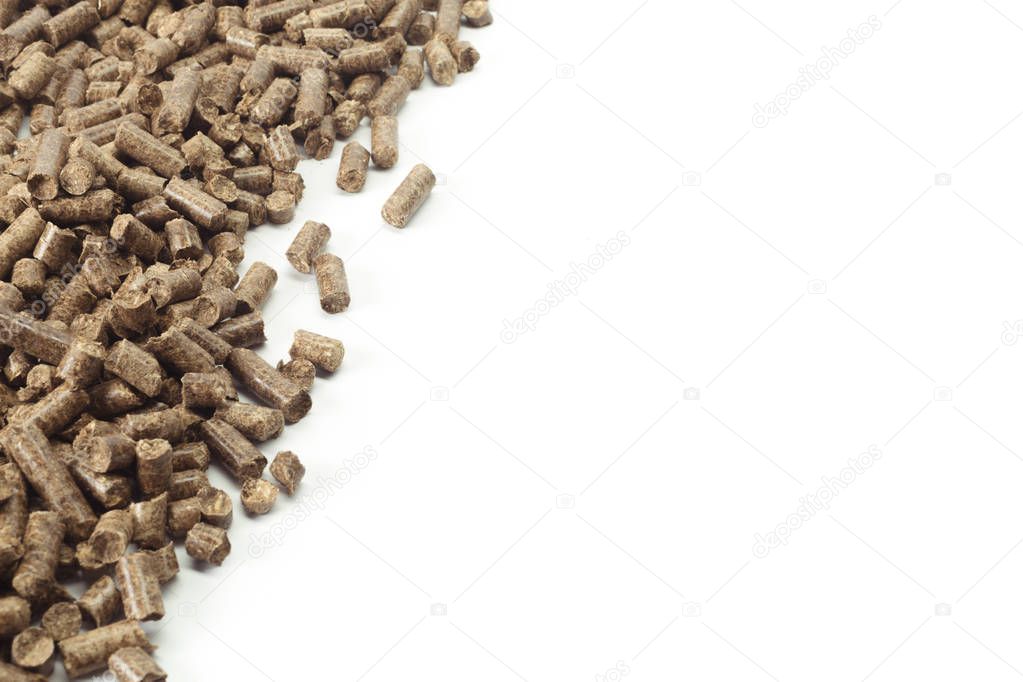 Bio Energy. Wooden pellets on white table.