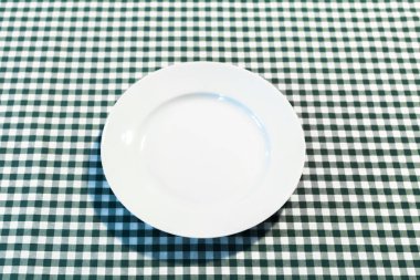 kareli masa örtüsü üzerindeki tabak