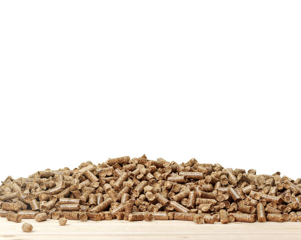 pile of wooden pellets on wooden board , close-up 