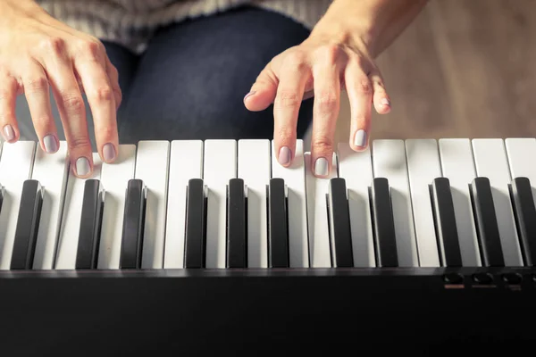 Closeup of hands playing piano. Music and hobby concept