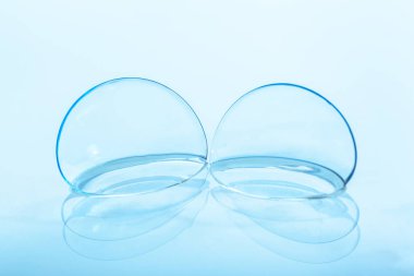 contact lens on blue background clipart