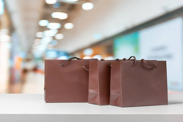 close-up shot of brown shopping bags on mall background