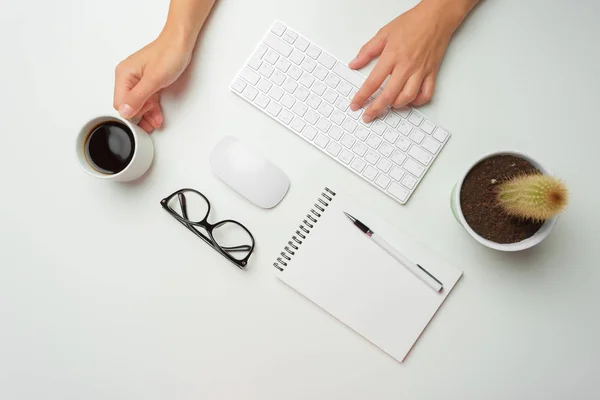 women\'s hands using keyboard and mouse