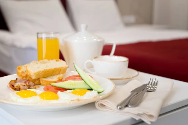 Breakfast in bed in hotel room