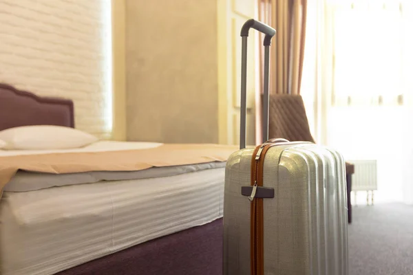 Stylish luggage bag in modern hotel room