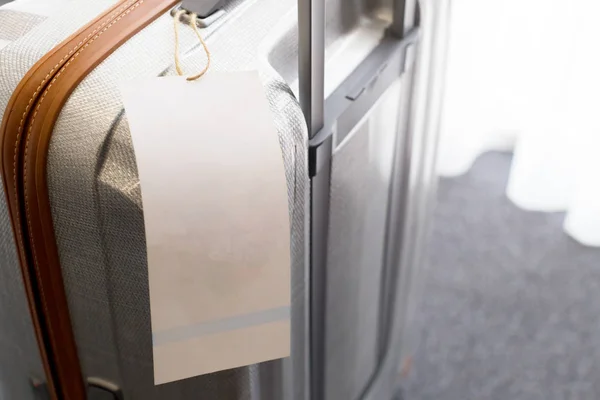 Close view of blank luggage tag label on suitcase