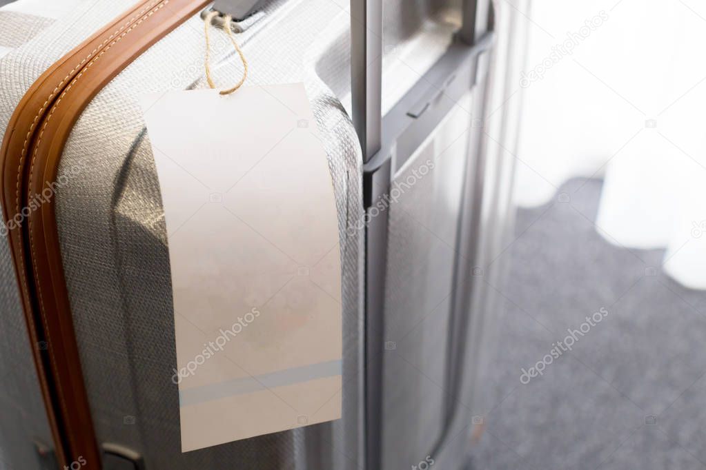 Close view of blank luggage tag label on suitcase 