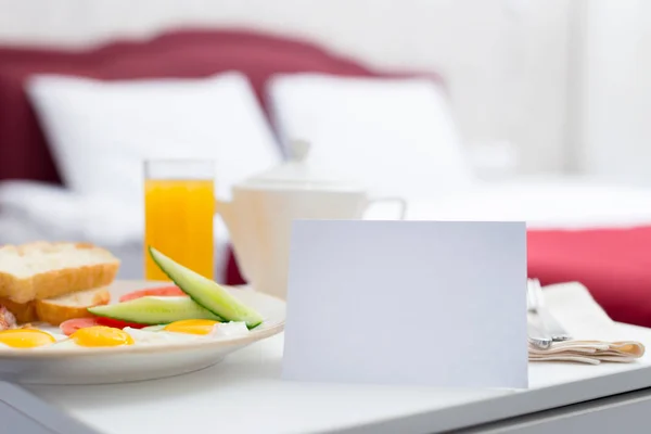 Fresh tasty breakfast by bed in hotel room