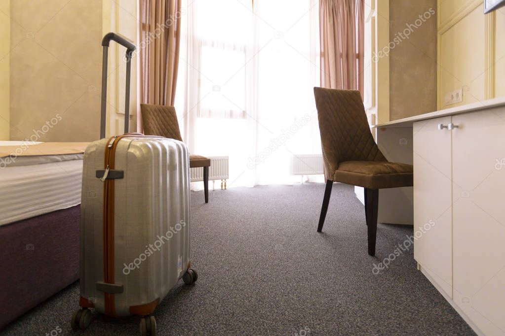 Stylish luggage bag in modern hotel room