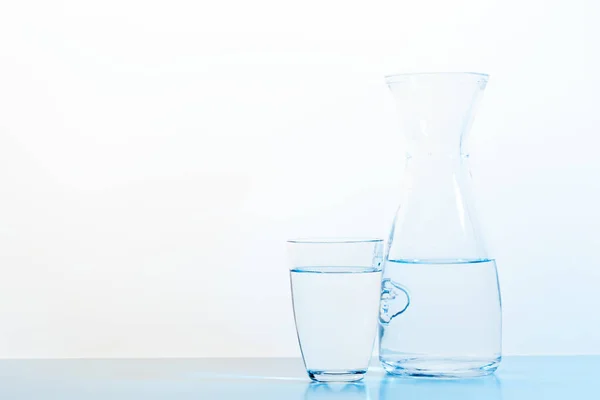 water glass and jug on light background