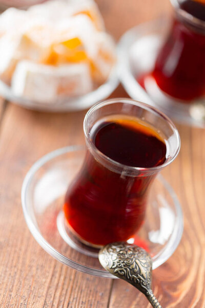 Red tea in turkish glasses on a wooden table