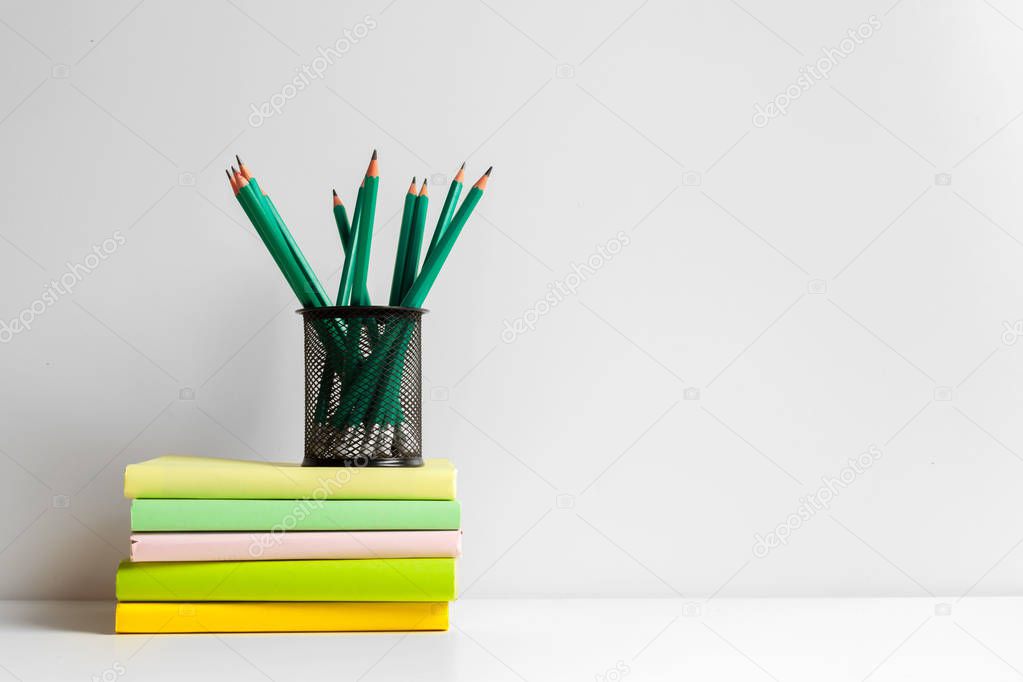 Green pencils in a holder,school supplies on the table 