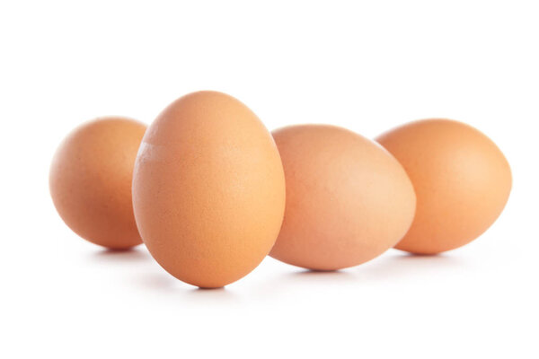 four organic eggs on white background