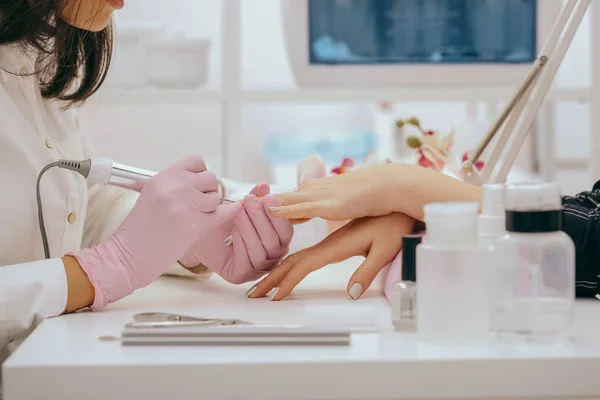 Manicurist with a milling cutter for manicure