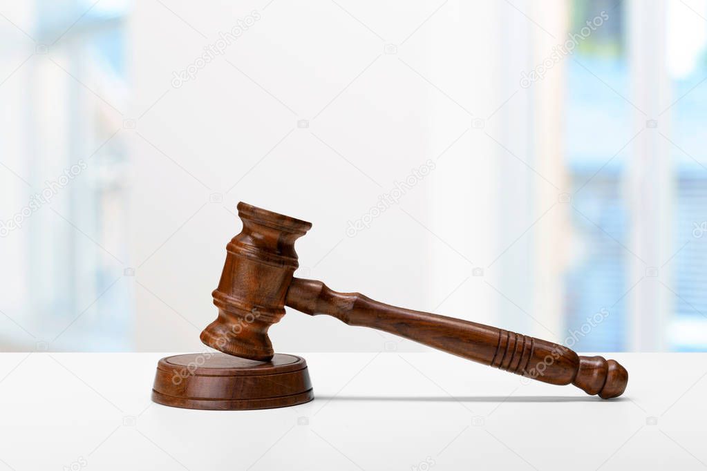 wooden judge gavel on white table