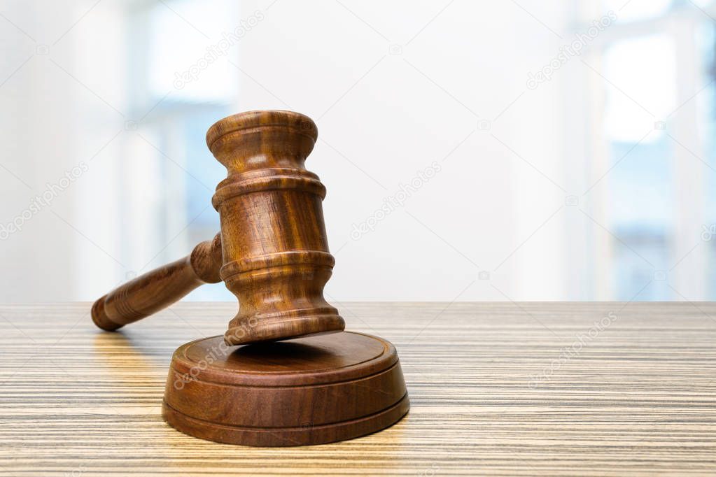 close up of wooden brown judge hammer on table