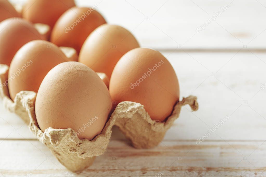 pack of eggs on wooden background