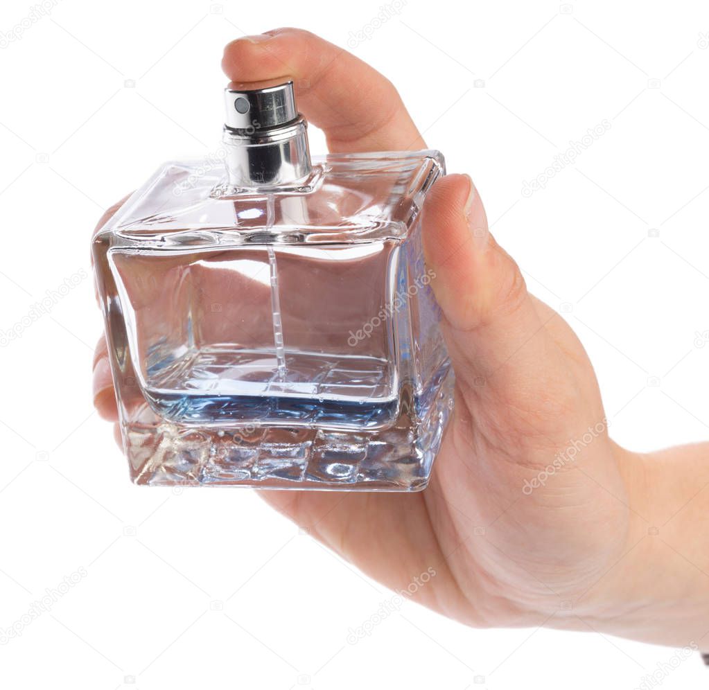 Woman hand with perfume bottle isolated on white background