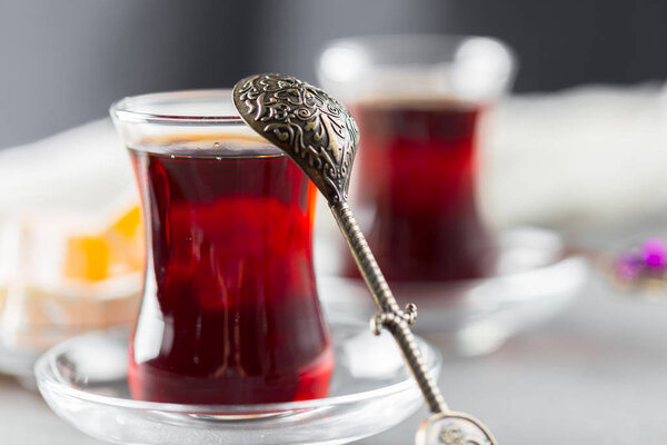 Red tea in Turkish glasses on wooden table