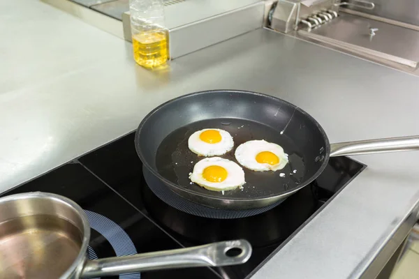 Fried eggs cooking in a restaurant