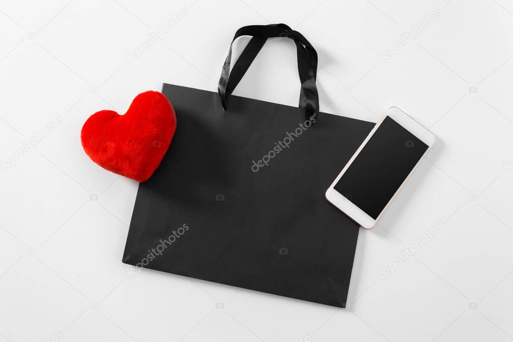 Shopping bag and smartphone isolated on white background 