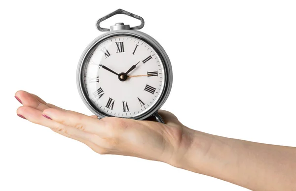 白い背景に分離された目覚まし時計を持っている女性の手 — ストック写真