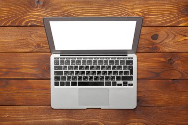 Laptop, defter üzerinde ahşap çalışma masası 