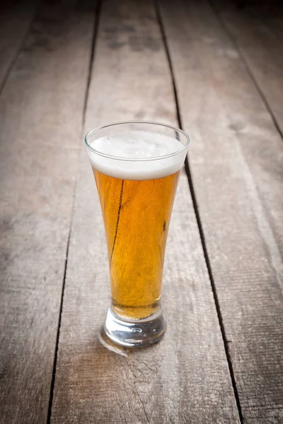 glass beer on wood background