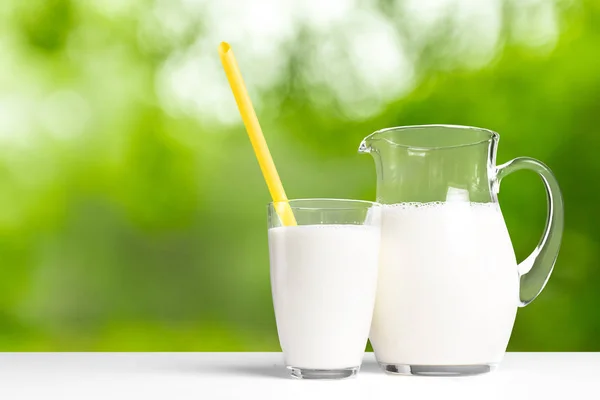 milk jar and glass on background,close up