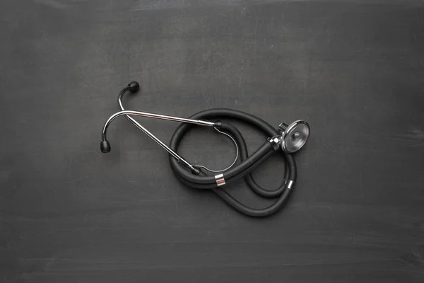 Black stethoscope on background,close up