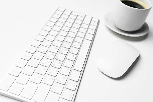 Office desk table with computer, supplies and coffee cup