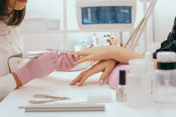 Manicurist with a milling cutter for manicure