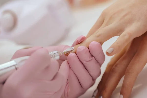 Manicurist with a milling cutter for manicure