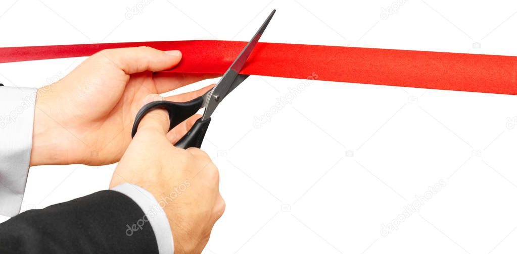businessman with Scissors cutting red ribbon or tape. Isolated on white background.