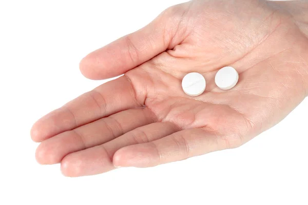 关闭的药片在妇女手查出的白色背景 — 图库照片